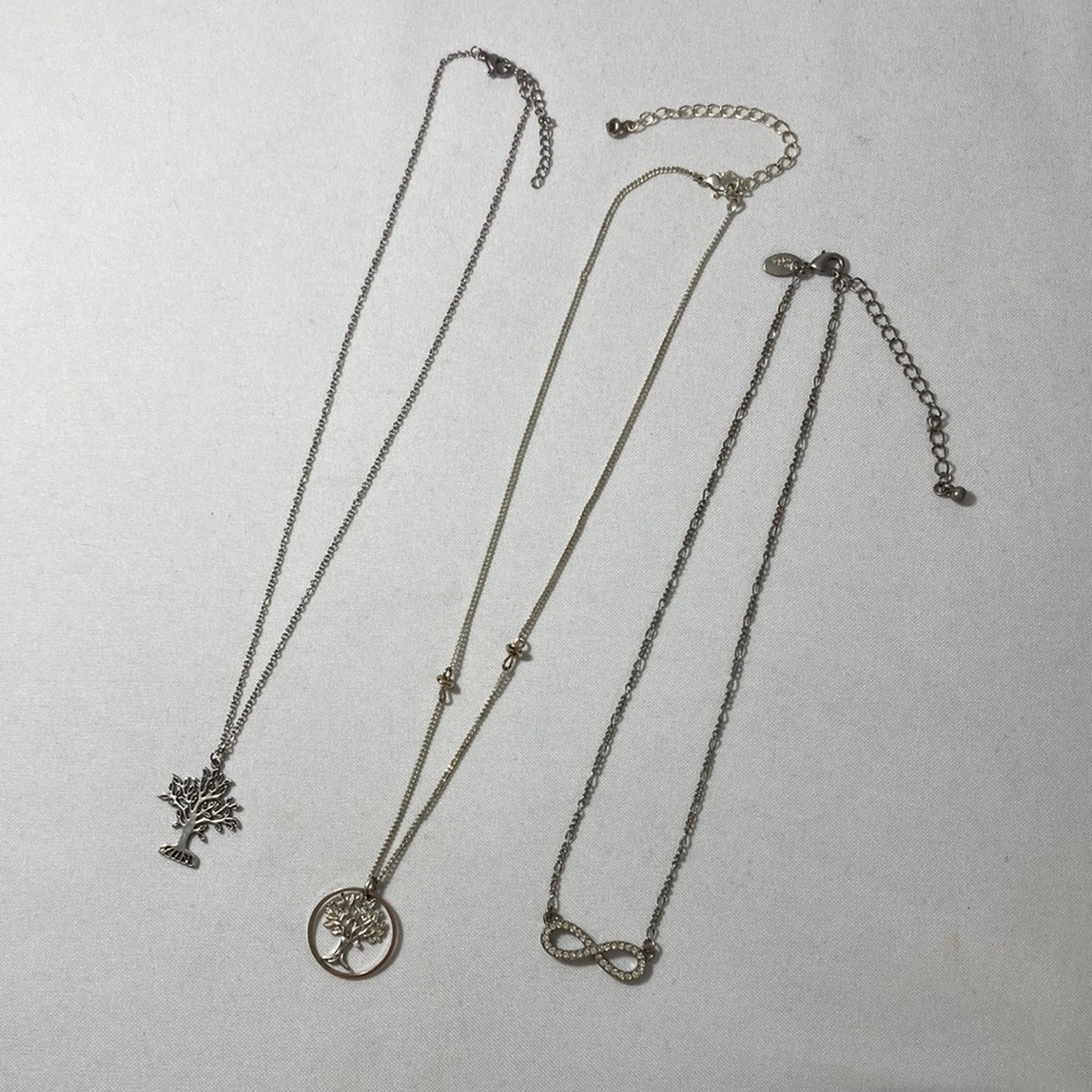 Three (3) fun necklaces. Two (2) tree necklaces and one (1) infinity necklace.